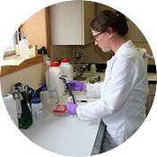 Woman pipetting samples in a lab setting